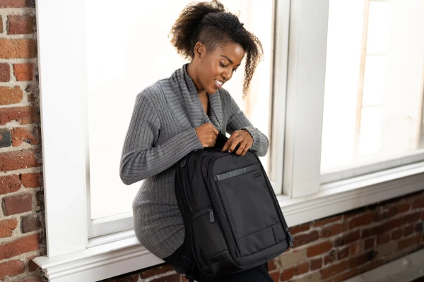 Person opening a backpack
